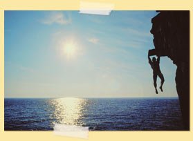 Image of dangling person off cliff
