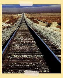 Image of railroad tracks in a desert-like area
